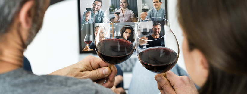 view from behind a man and woman looking ahead while holding wine glasses up to a computer screen